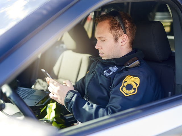 police officer using modernized next-generation 9-1-1 to leverage text messages, apps, and more 